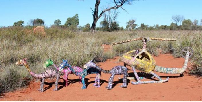 sculpture of a helicopter chasing camels, Crafted from wire, tjanpi (wild harves